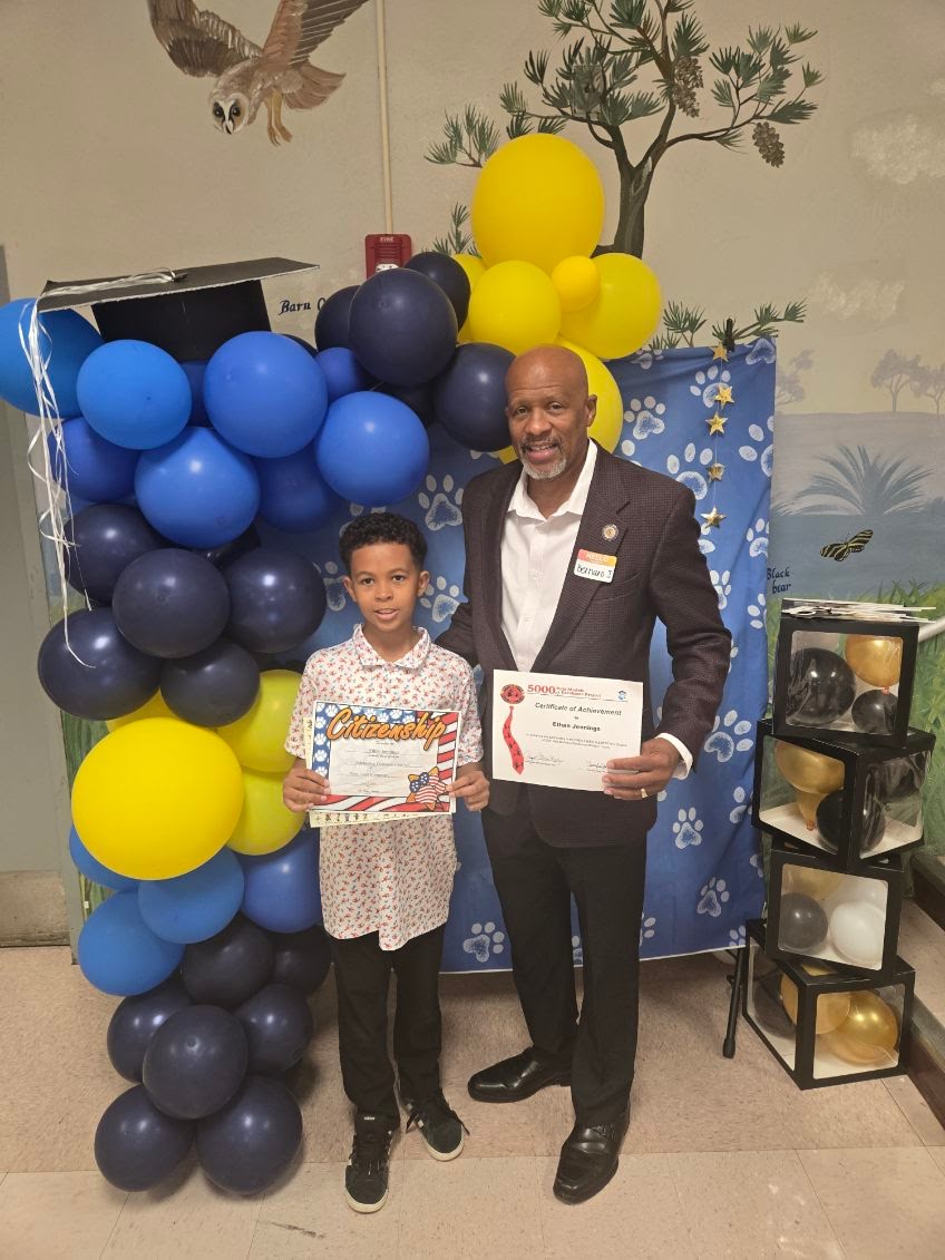 Dr. Jennings presenting a certificate of achievement to a student