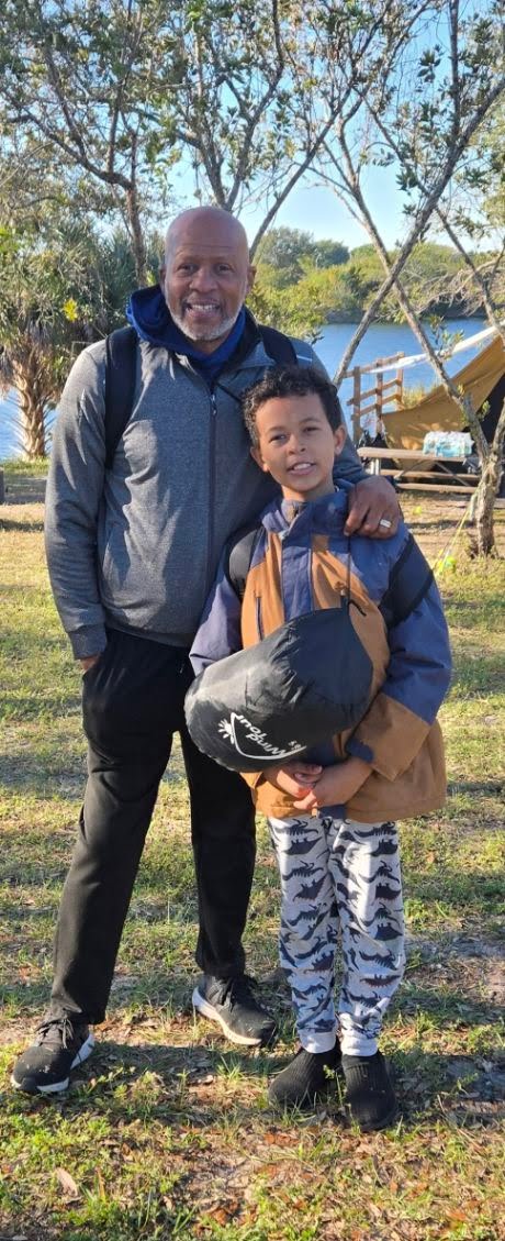 Dr. Jennings with a young student on a community camping trip